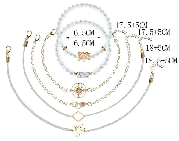 6 auksinių ir kreminių apyrankių rinkinys su drambliu ir palme