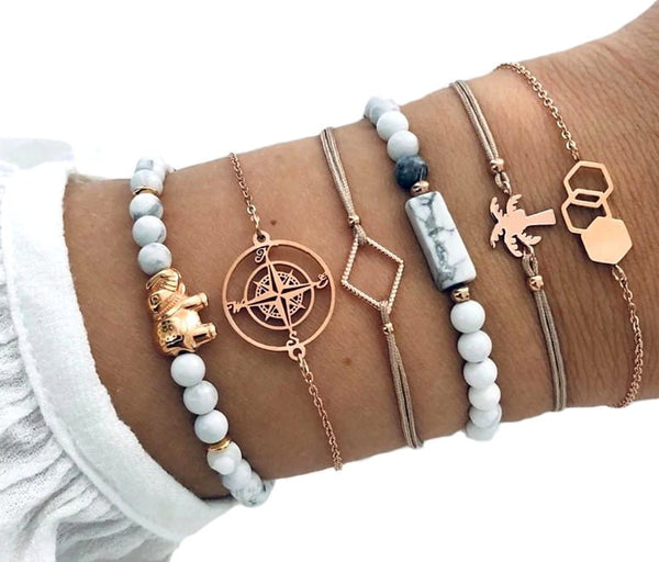 6 auksinių ir kreminių apyrankių rinkinys su drambliu ir palme